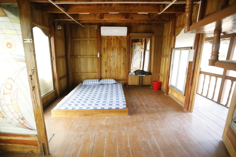 Wide timber bedroom inside Aadi Kuthi