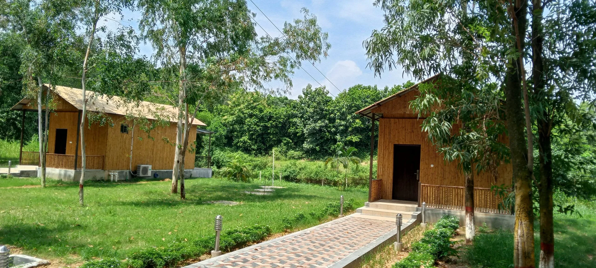 Cybele bamboo cottage beside a garden path