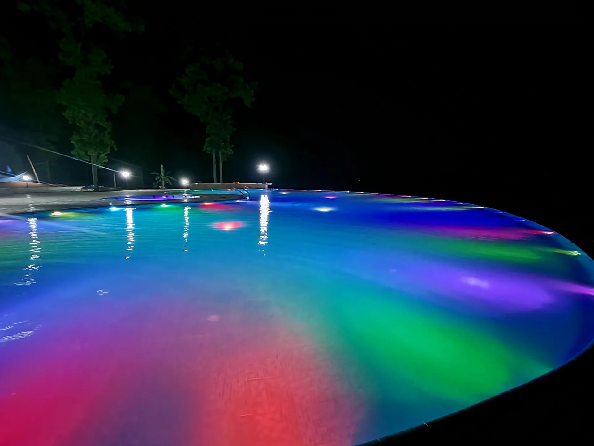 Resort swimming pool illuminated after dusk